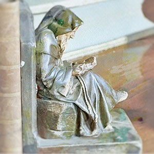 plaster bookend of a medieval monk reading